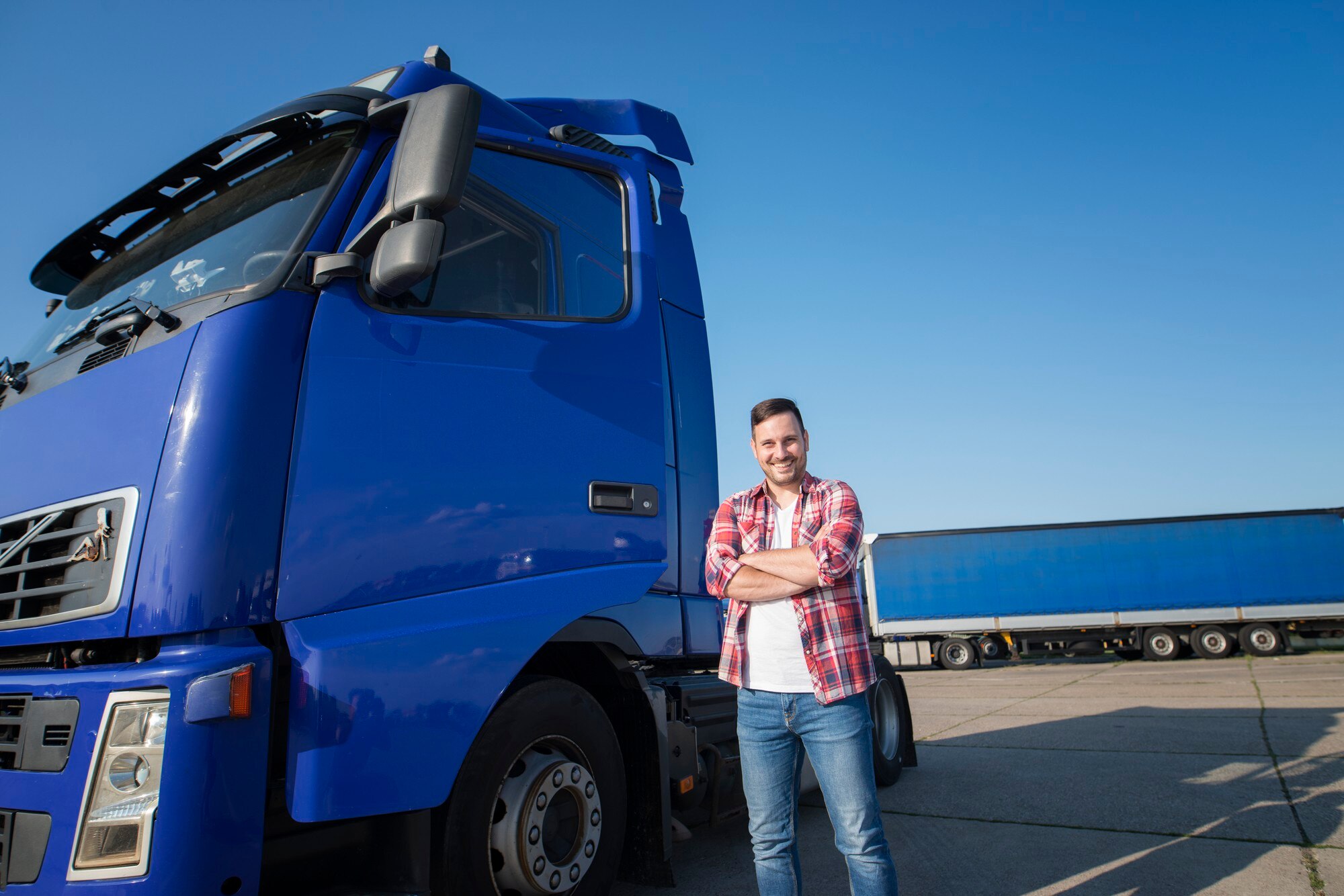 Driver Standing Beside a Truck